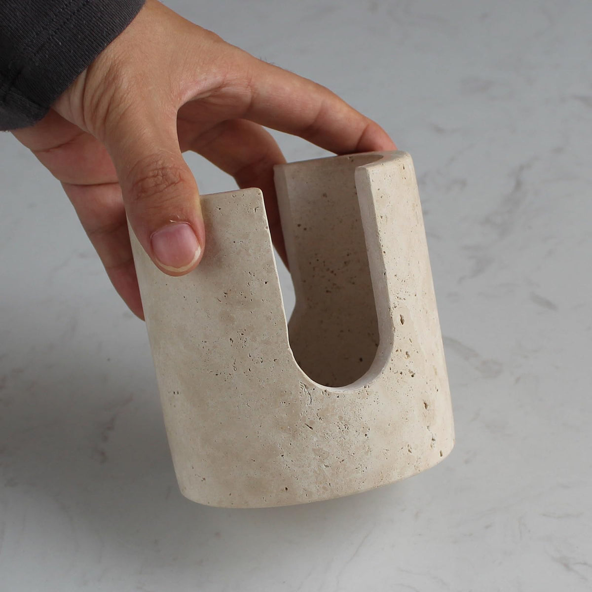 Natust beige travertine sink organizer adds compact storage.