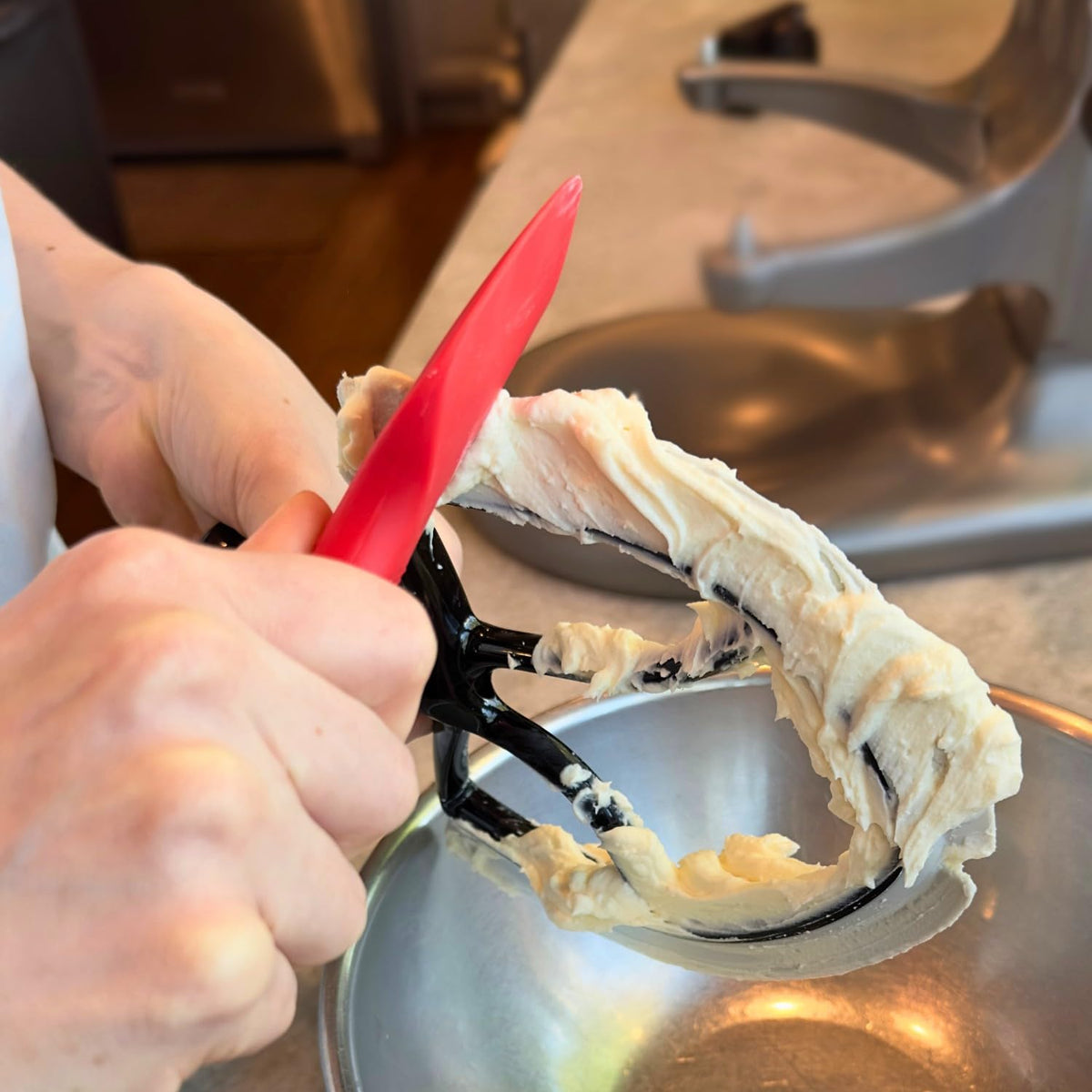 New Metro Design Spatula ONE batter-scraper clears batter from beater blades for minimal waste.