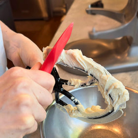 New Metro Design Spatula ONE batter-scraper clears batter from beater blades for minimal waste.