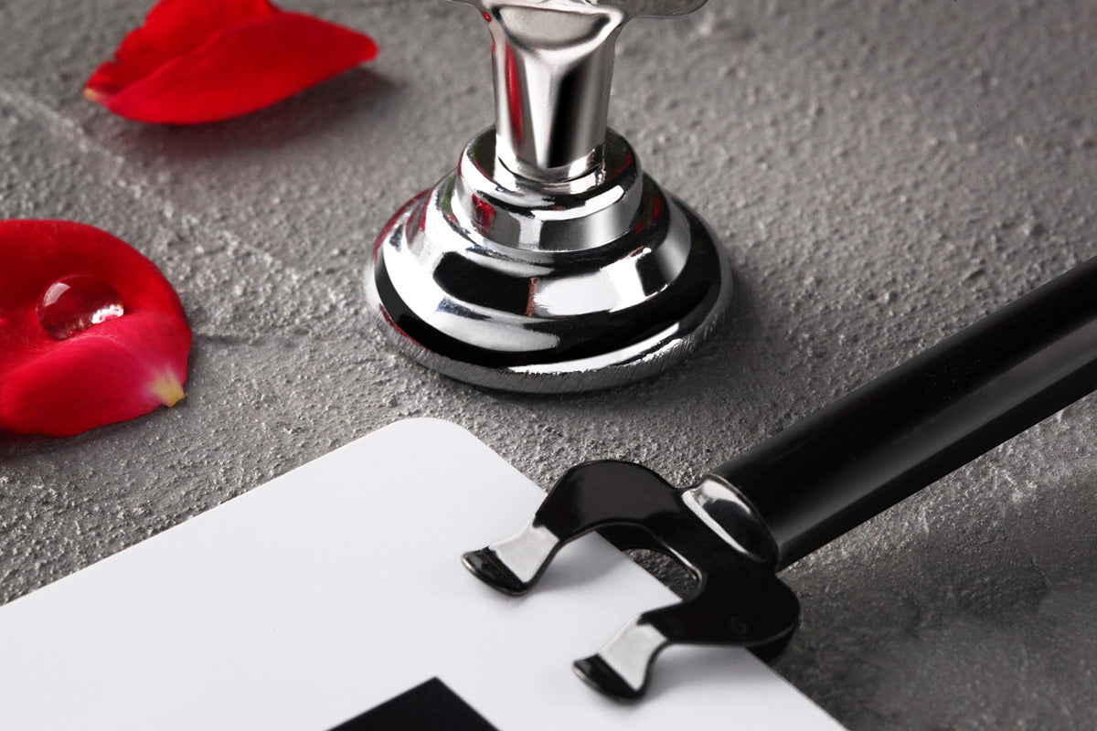 New Star Foodservice Triton Harp Clip Place Card Holder in black features a durable metal finish.