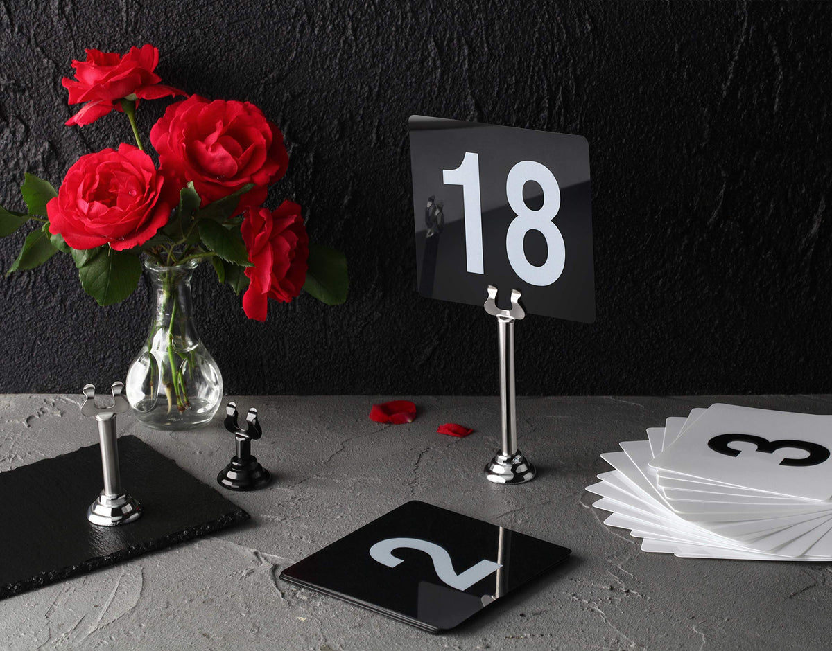 New Star Foodservice Triton Harp Clip Place Card Holder in black enhances restaurant tabletops.