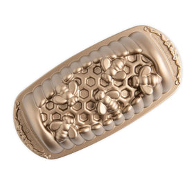 Nordic Ware Honey Hive Loaf Pan with honeycomb texture and 6-cup capacity for even browning
