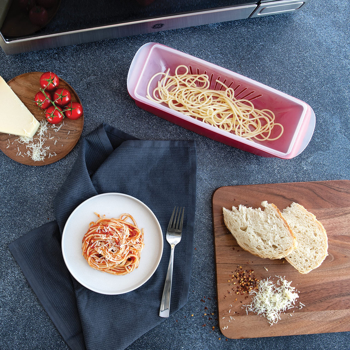 Nordic Ware microwave pasta cooker with strainer cover for easy sauce-ready pasta.