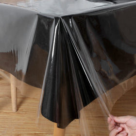 Obstal clear tablecloth on dining table showing water resistance.