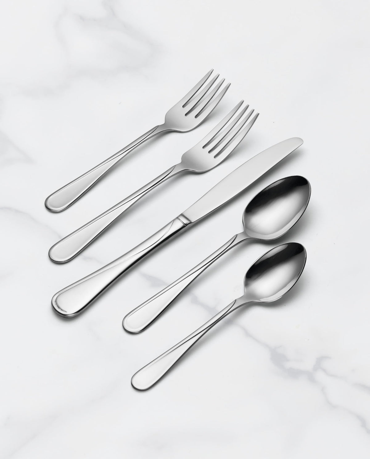 Hand holding Oneida Flight flatware illustrating comfortable grip and timeless style