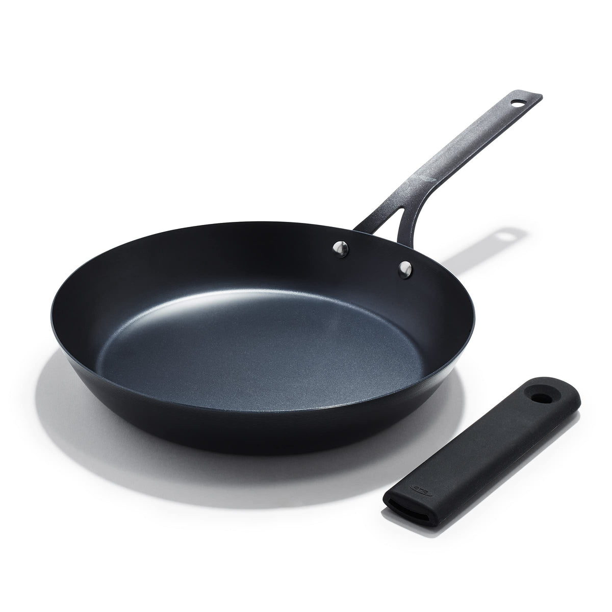 OXO Obsidian 12-inch carbon steel pan on stove delivering even heat for searing