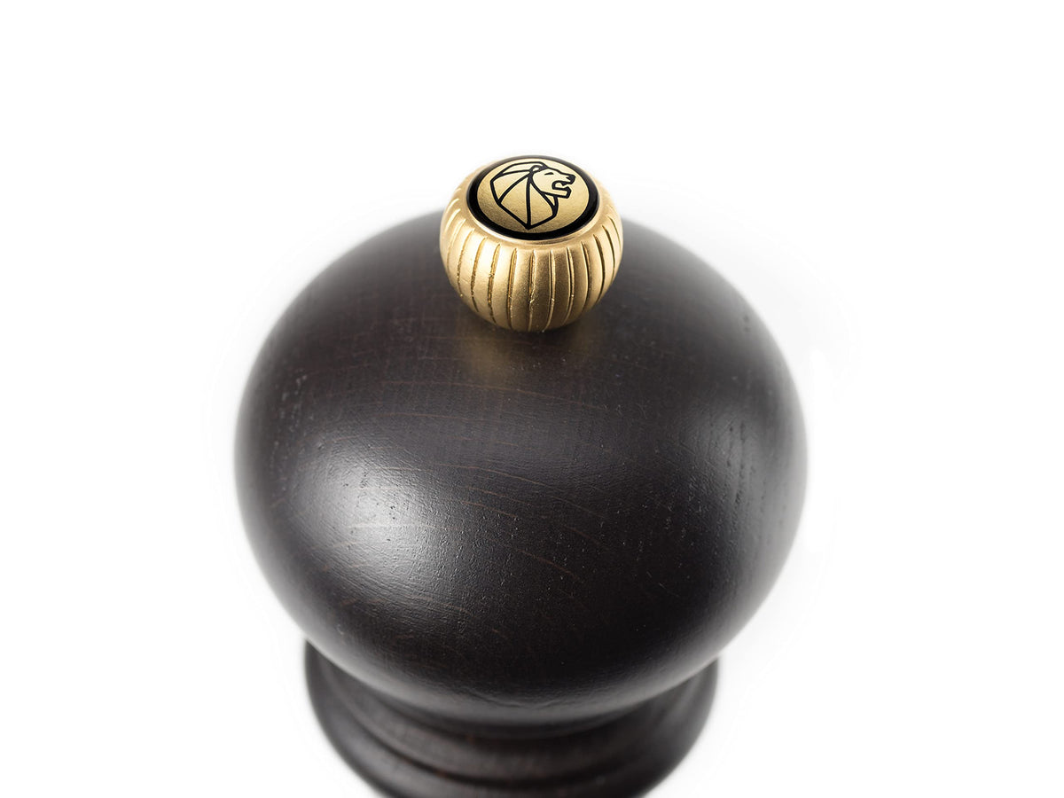 Top-knob refill area on Peugeot pepper mill for easy peppercorn loading.