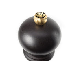Top-knob refill area on Peugeot pepper mill for easy peppercorn loading.