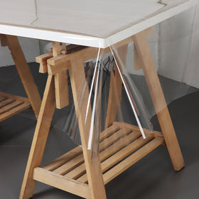 Pioggia clear tablecloth protector rectangle dining setup on a kitchen table.