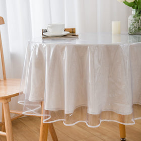 Pioggia clear round tablecloth showcases settings and protects the table