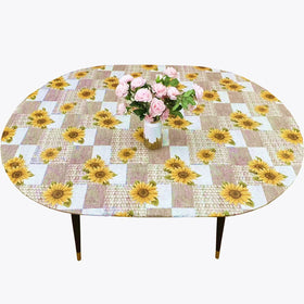 Pioggia oval vinyl fitted tablecloth with flannel backing protects oval tables up to 42x60.