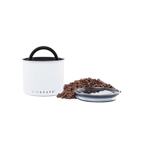 Planetary Design Airscape stainless steel canister demonstrates push-out-air action to preserve freshness.