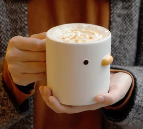 Close-up of hand-glazed chick mug showing unique texture and craftsmanship.