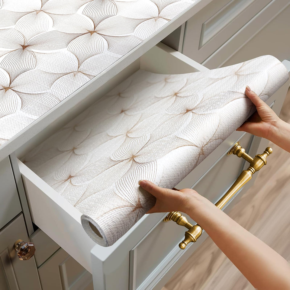Quttisay shelf liner with flower pattern protects kitchen cabinets from scratches and spills.