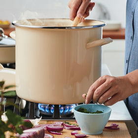 Rachael Ray almond cream enamel stockpot during cleanup, easy to wipe.