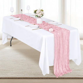 RealBox baby shower table setting with soft pink semi-sheer fabric.