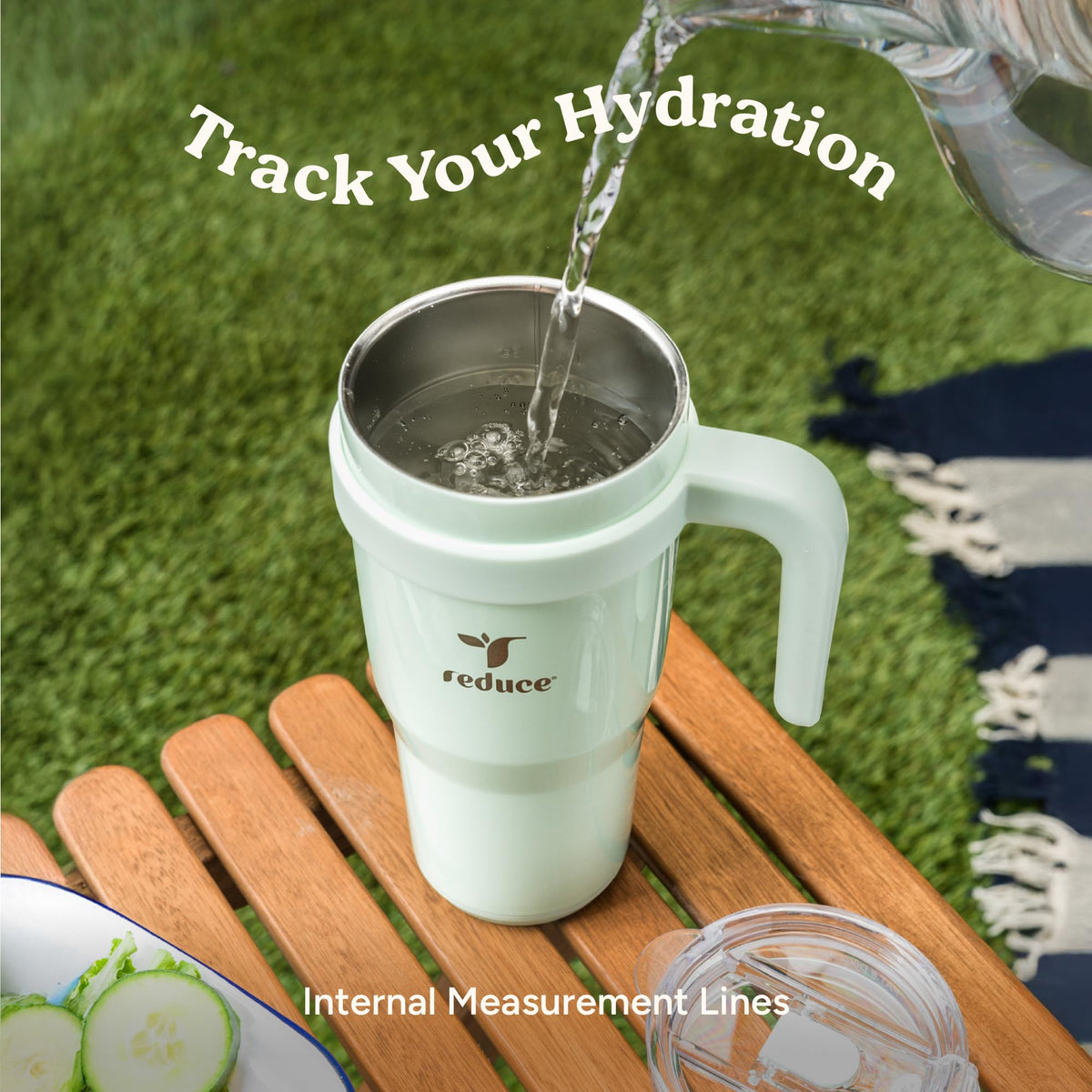 REDUCE 24oz tumbler held in hand during outdoor activity
