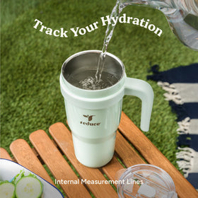 REDUCE 24oz tumbler held in hand during outdoor activity