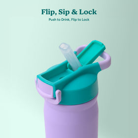 REDUCE Hydrate Pro Kids bottle next to a cupholder for quick access.