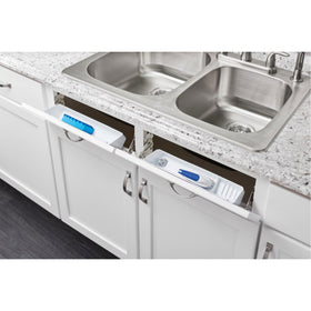 Rev-A-Shelf tip-out tray in base cabinet with door open, maximizing hidden storage.