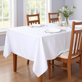 Sancua dining table protection with stain-resistant tablecloth under food spread.
