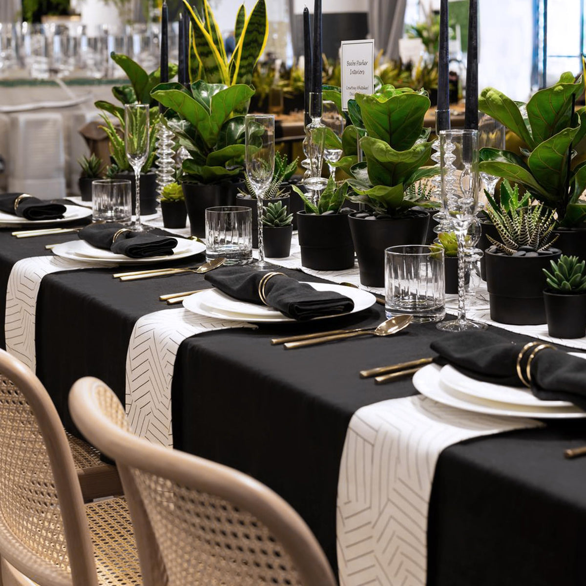 Sancua black tablecloth over buffet setup demonstrates stain resistance during service.