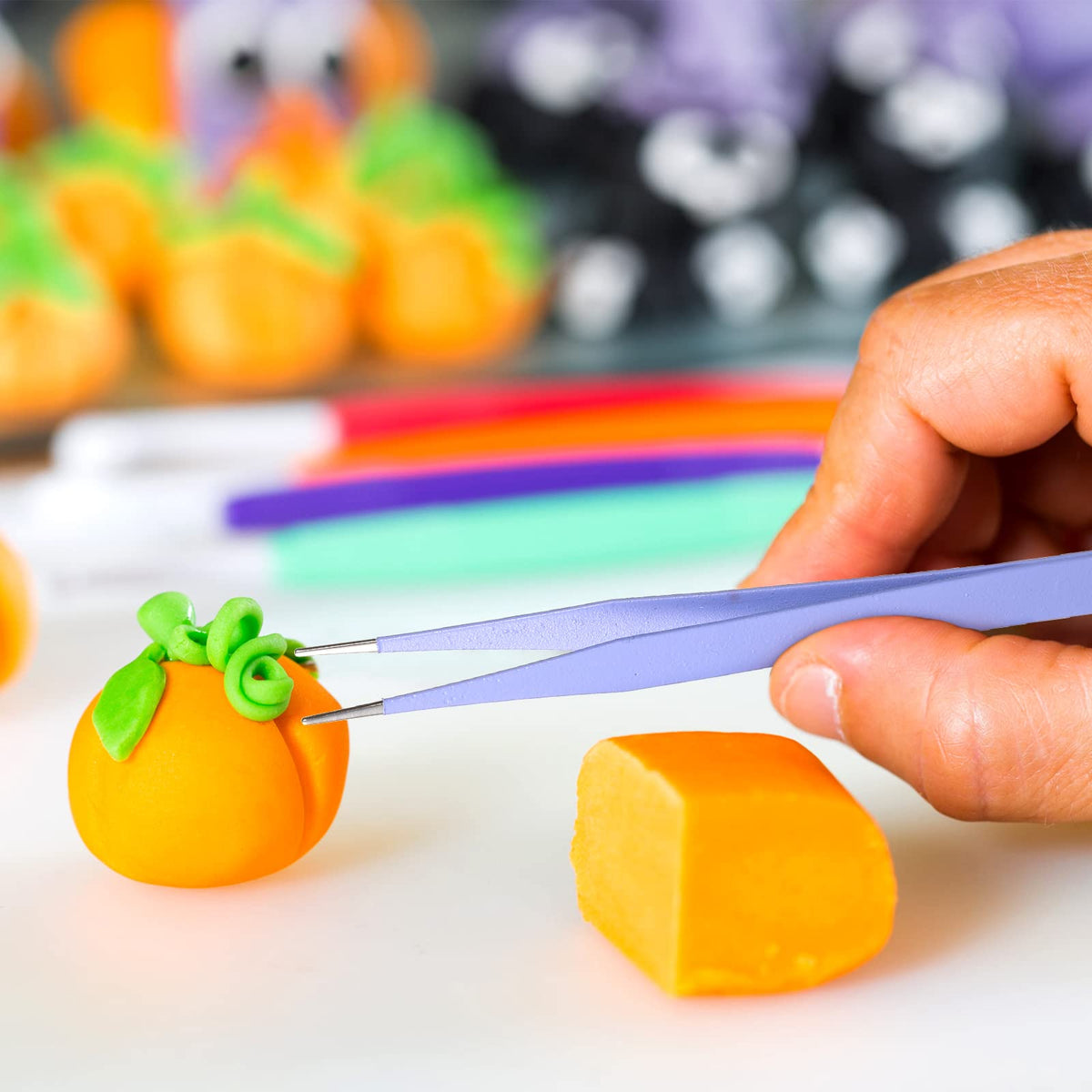 Sinmoe curved-tip tweezers help lift delicate sugar work without damage.