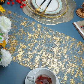 Snowkingdom gold sequin table runner used as centerpiece decor for birthdays and anniversaries.