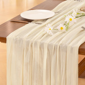 Socomi beige cheesecloth table runner draped on a 120-inch table for festive dining.