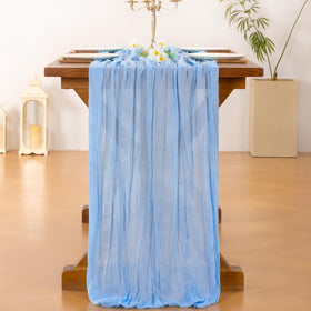 Socomi blue cheesecloth runner draped on a dinner table adds rustic-elegant charm.