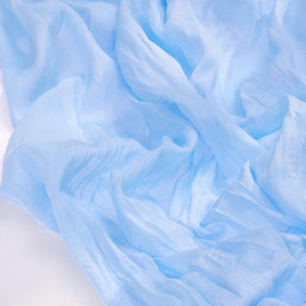Socomi blue summer cheesecloth runner shown on wedding arch for graceful decor.