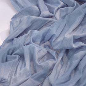 Socomi dusty blue cheesecloth runner over arch for airy wedding decor