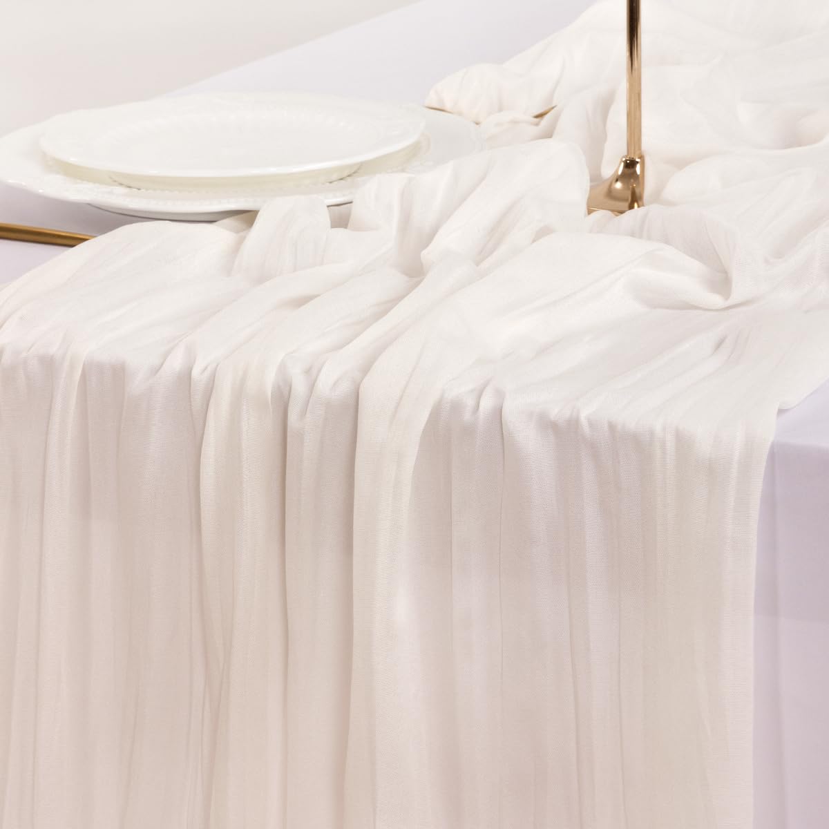 Socomi ivory cheesecloth runner used for holiday table decor.