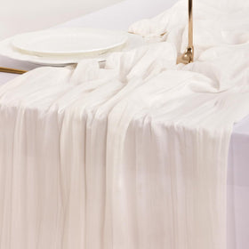 Socomi ivory cheesecloth runner used for holiday table decor.