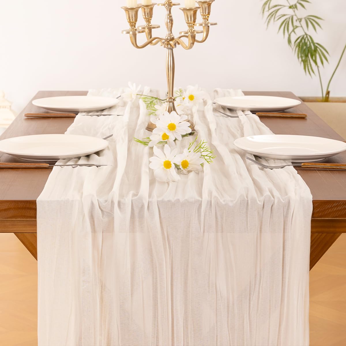 Socomi ivory cheesecloth runner adds rustic texture to a dining table.