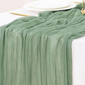 Socomi sage green cheesecloth table runner in 120 inches adds soft, versatile elegance to tables.