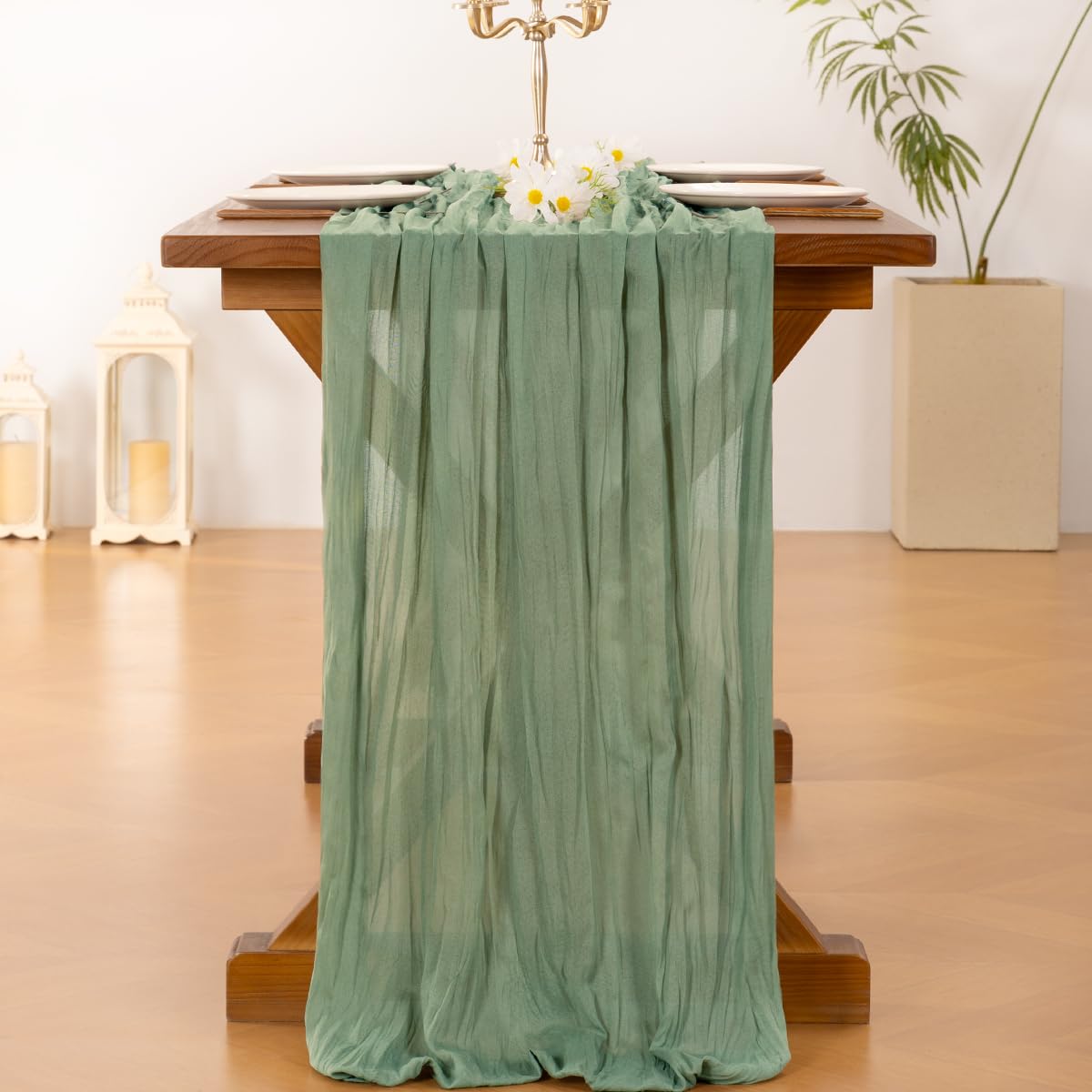 Socomi wedding table setup with sage green cheesecloth creates a boho rustic vibe for guests.