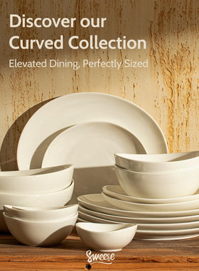 Sweese elegant dining setup with six white plates on a table.