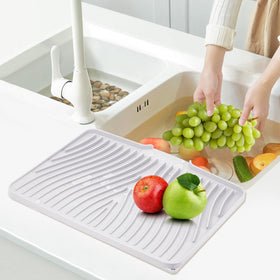 TIKNIK easy-clean mat being rinsed to demonstrate quick maintenance.