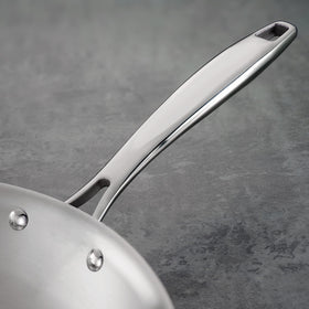 Induction-compatible Tramontina tri-ply pan on a magnetic hob.
