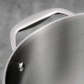 Tramontina Signature Tri-Ply clad aluminum-core illustration emphasizes even heat distribution.