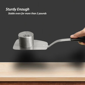 XiaoZu spatula flipping eggs gently to prevent breakage.