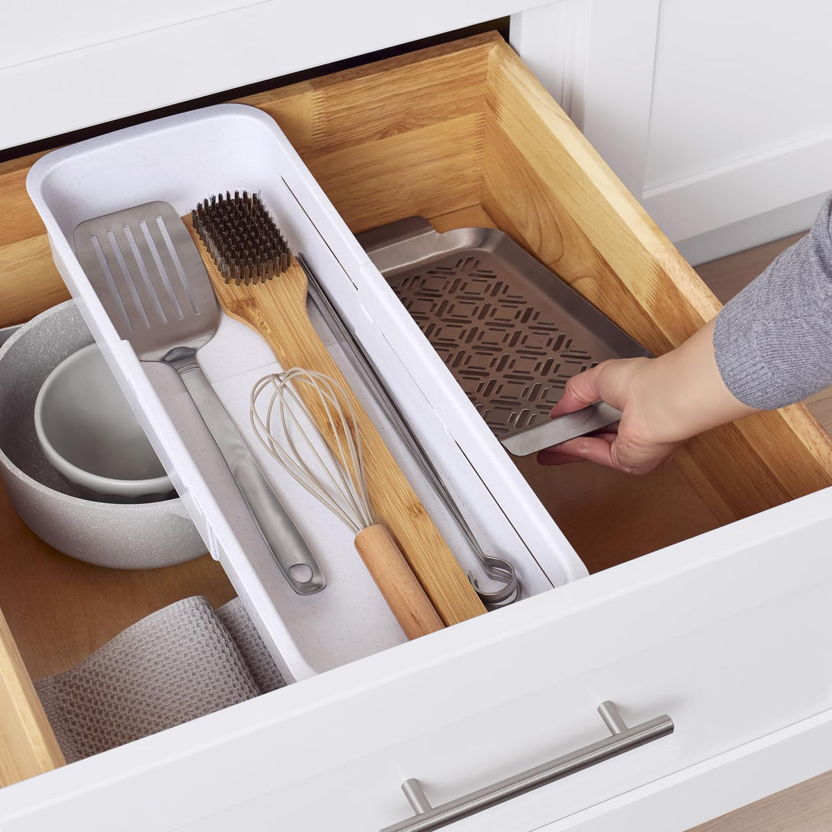 YouCopia DrawerFit bin on the drawer frame teeth keeps length secure during use.