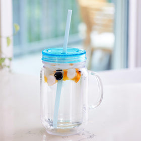 Zephyr Canyon hands holding mason jar with spill-free design for on-the-go sipping.
